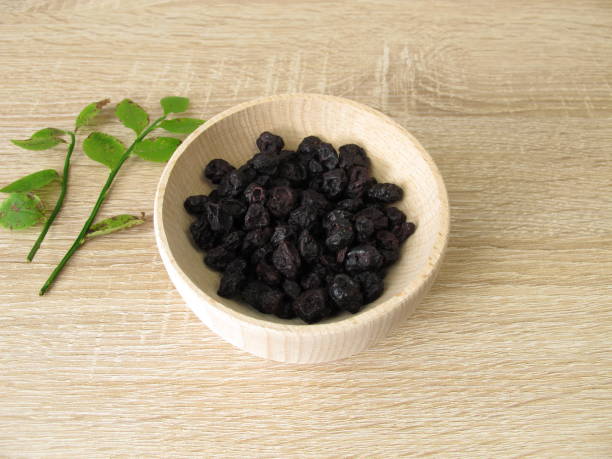 istock Dried blueberries in a wooden bowl 1144727717