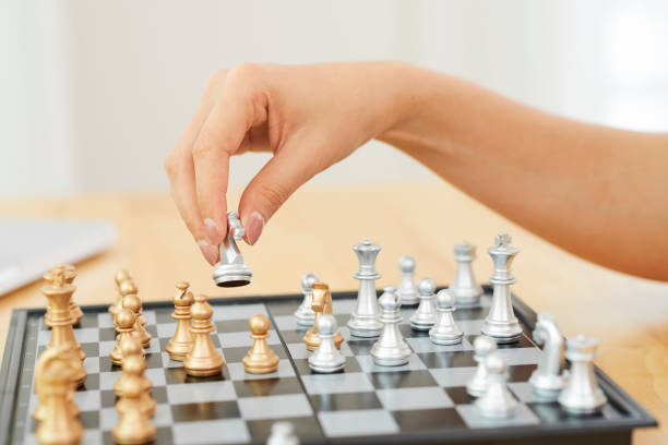 istock Hand of woman playing chess 1144729408