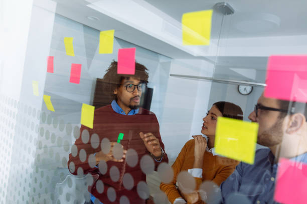 istock Business people brainstorming ideas behind glass wall 1144729480