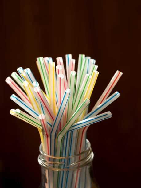 istock Multi Color flexible straws on dark background. 1144729835