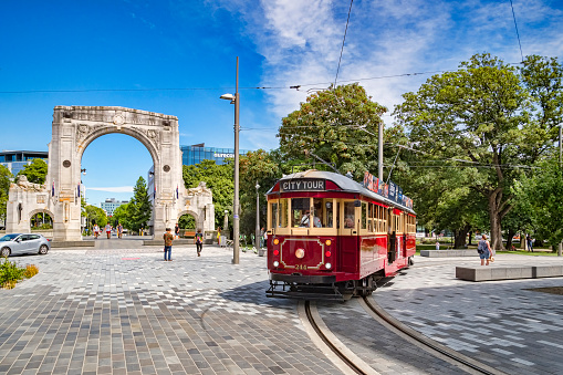 3 January 2019: Christchurch, New Zealand - A vintage tram turns into Cashel Street near the Bridge of Remembrance in the centre of Christchurch.