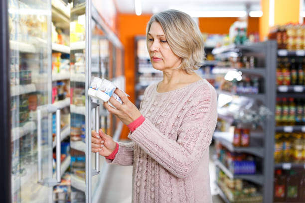 istock Mature woman choosing dairy products 1144732256