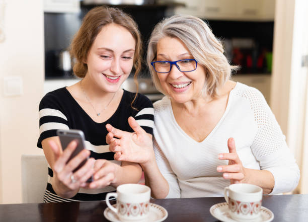 istock Mother with daughter using smartphone 1144732339