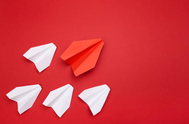 istock winner red  paper aircraft on red background - Image 1144732987