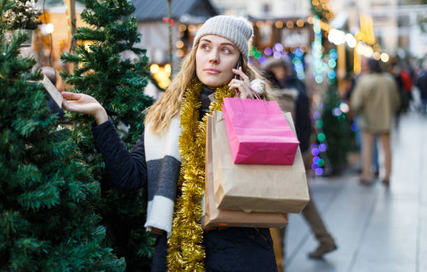 istock Woman talking on mobile phone at fair 1144737742