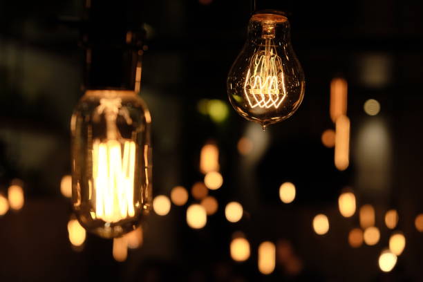 close up decorative antique edison style shining bulbs. blur black background