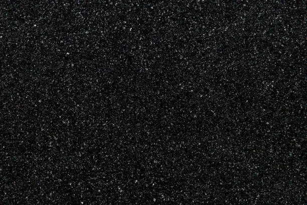 The texture of black stone (minerals) crumb. Black abstract background. Top view.