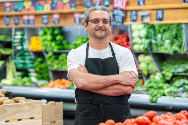 istock 2Mature man working at a supermarket vegetables section 1144739312