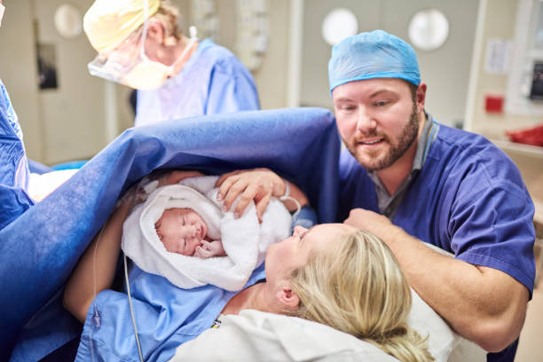 She's perfect in every tiny way Shot of a beautiful young couple welcoming their newly born baby girl in the hospital labor childbirth photos stock pictures, royalty-free photos & images