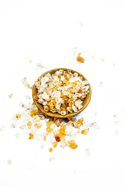 Photo of Close up of popular Indian &Asian spices isolated on white in a glass plate i.e.  Khatira gond or quatira gond or Indian edible gum or common edible gum or goundh or gound or acacia gum.