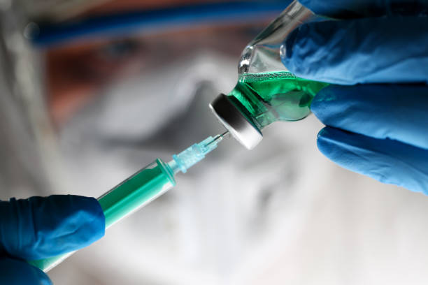 istock Pharmacist Syringe Dosing Green Liquid Vaccine 1144743837