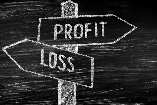 Profit and loss concept on blackboard