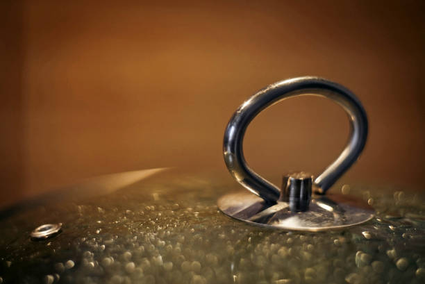 istock Close-up glass cover from pan, covered with condensate. Blurred bokeh cooking concept background. Soft defocused shot 1144745708