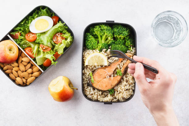 istock Man eating nutrition lunch from takeaway lunch box. 1144746887