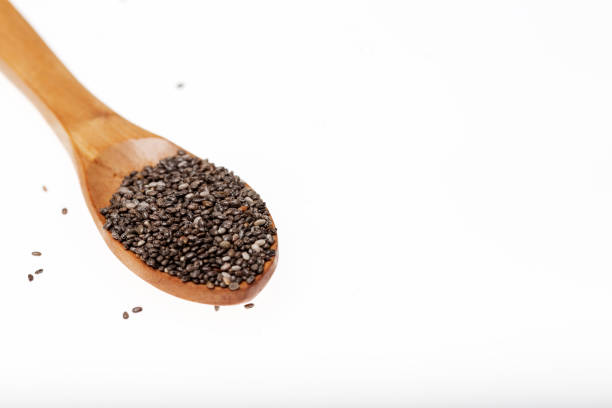 istock Chia seeds in wooden spoon on white background. 1144747226