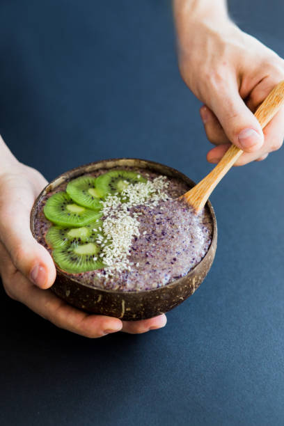 istock Healthy purpur smoothie , plate made from coconut shell on dark background 1144749331