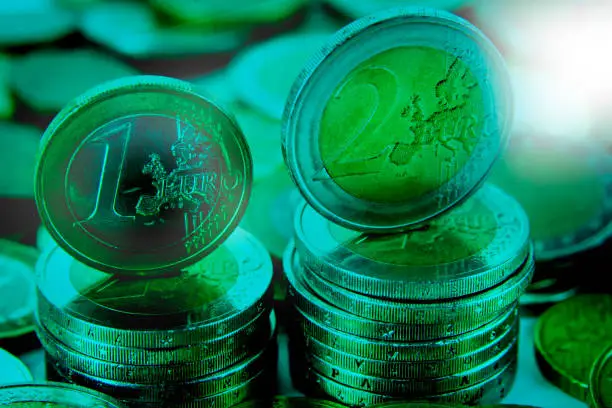 Closeup of eurocoins stand on a pile of coins