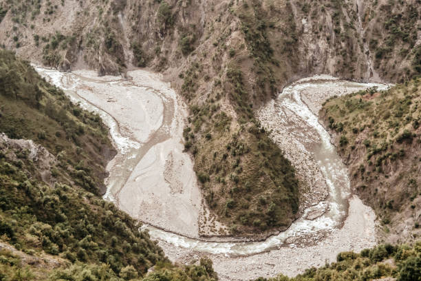 istock Great Himalayan U shape valley, with steep, straight sides and rounded bottom carved by Ganges river tend to be V shape. Its a natural glaciated valleys formed by glacier travel down a hill slope. 1144750297