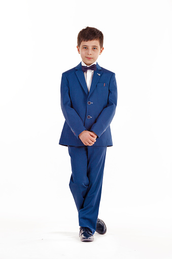 Kids fashion. Boy in an elegant jacket and pants isolated on white background. Businessman boy.