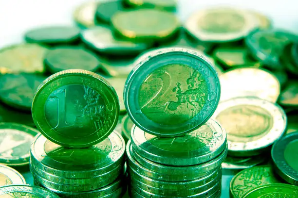 Closeup of eurocoins stand on a pile of coins