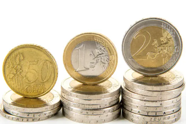 Closeup of eurocoins stand on a pile of coins