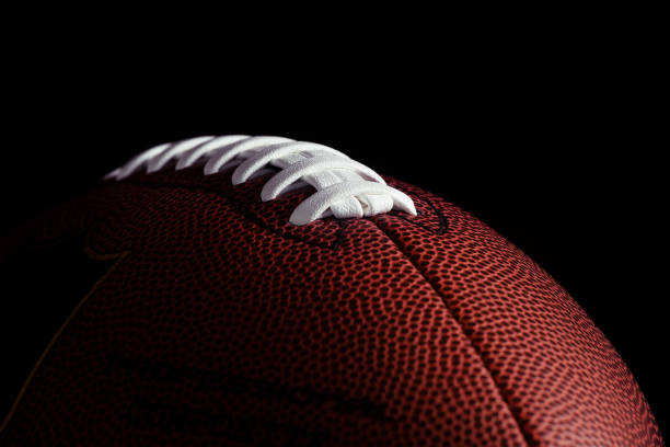 American football on dark background American football on dark background american football ball photos stock pictures, royalty-free photos & images
