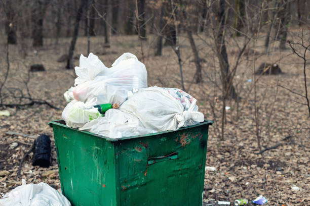 istock Old rusty metal green garbage container full with plastic waste standing in city park or forest. Environmental pollution 1144753594