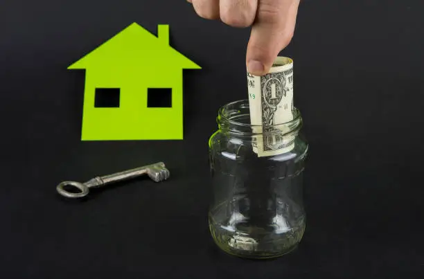 Green house save money. A jar with euro or dollar