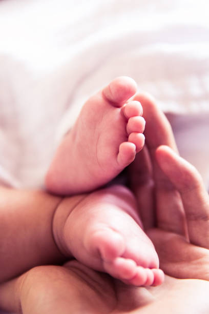 istock Baby foots in mother hands 1144755626
