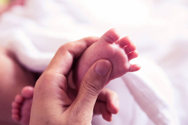 istock Mother doing newborn baby feet massage 1144755764