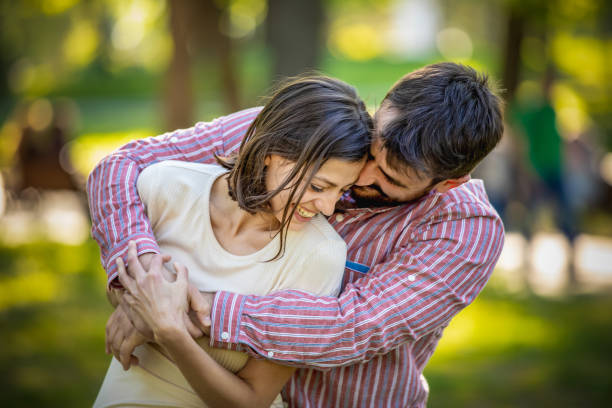 istock Young Couple is Enjoying Springtime in Park 1144756562