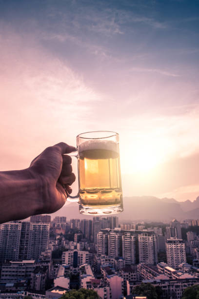 istock Hand holding summer beer in the city 1144756997