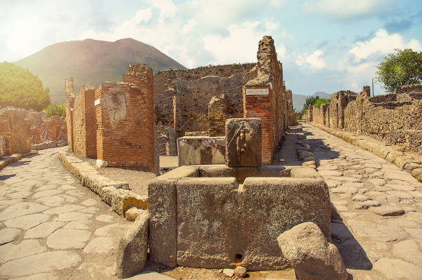Ancient water well in Pompeii on Mount Vesuvius background, Campania, Italy. Ancient water well in Pompeii on Mount Vesuvius background, Campania, Italy. Roman streets herakleion photos stock pictures, royalty-free photos & images