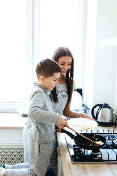 istock Mother and little son preparing food in kitchen 1144758104