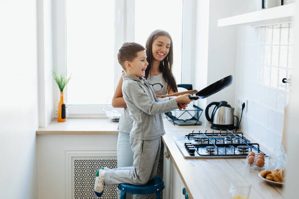 istock Mother and little son preparing food in kitchen 1144758320