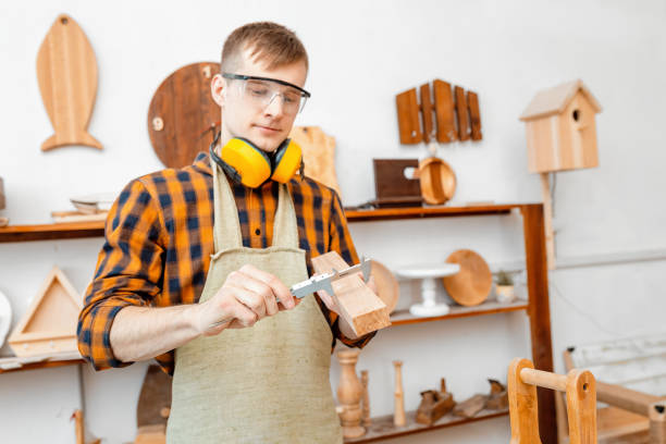 istock male carpenter measuring a wooden workpiece with a caliper 1144759865