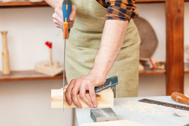 istock Carpenter Working with saw on a construction site. labor safety concept 1144759882