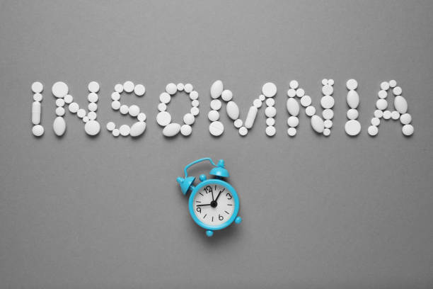 istock Sleeping pills and an alarm clock, insomnia concept. Trouble falling asleep 1144760083