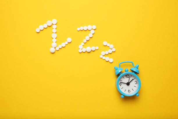 istock Sleeping pills and an alarm clock, insomnia concept. Night depression, anxiety 1144760087