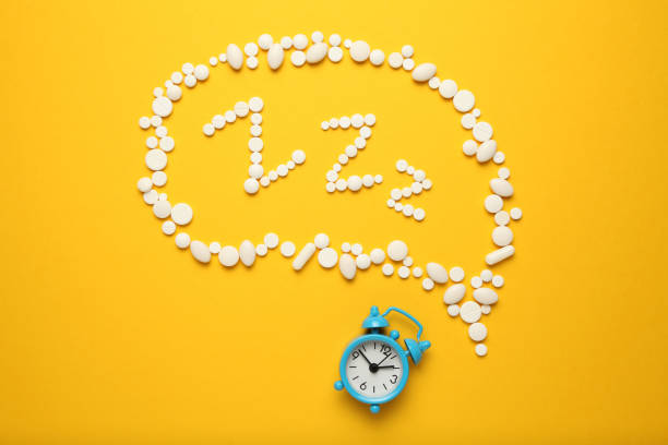 istock Sleeping pills and an alarm clock, insomnia concept. Medications for fatigue and sleep problems 1144760089