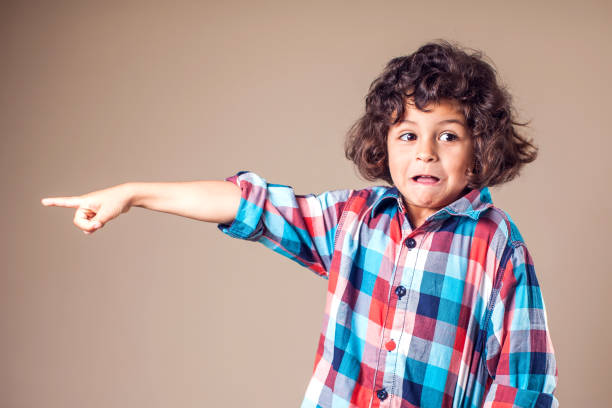 istock Little boy shows on something. Children and emotions concept 1144763412