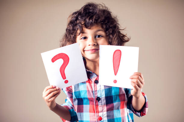 istock Thinking kid boy with question and exclamation signs 1144763459
