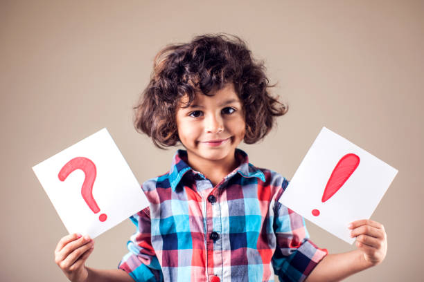 istock Thinking kid boy with question and exclamation signs 1144763469