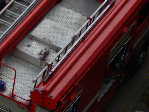 27.07.2024 Warsaw, Poland. A vibrant fire engine parked on a residential street in Warsaw, viewed from above. The scene captures the readiness and presence of emergency services in the city.
