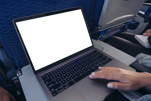 istock Mockup image of a woman using and touching on laptop computer touchpad with blank white desktop screen while sitting in the cabin 1144765962