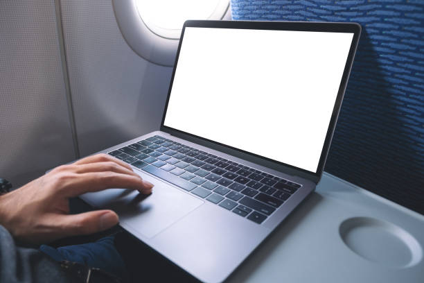 istock Mockup image of a man using and touching on laptop computer touchpad with blank white desktop screen while sitting in the cabin 1144766206