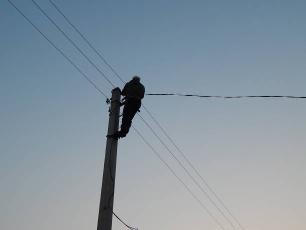 istock Electrician works in special clothes on the pole 1144766249