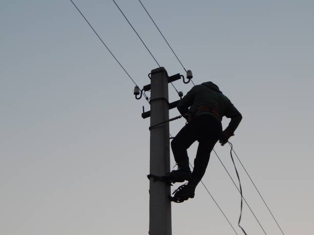 istock Electrician works in special clothes on the pole 1144766260