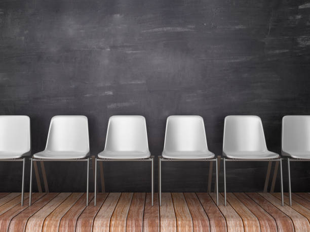 istock Row of Chairs on Wood Floor - Chalkboard Background - 3D Rendering 1144769172