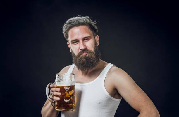 istock Young Man Holding a Glass of Beer 1144769676